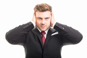 Handsome business man covering ears like deaf gesture
