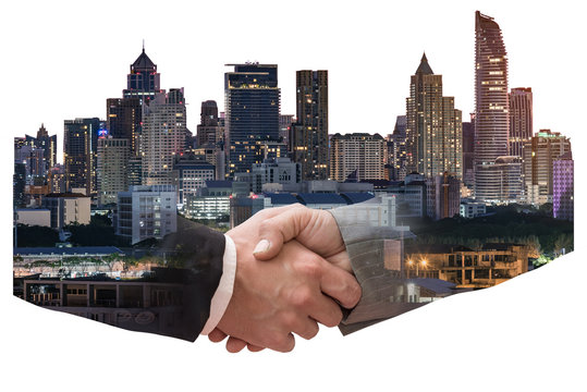 The double exposure image of the business man handshaking with another one during sunrise overlay with cityscape image. The concept of modern life, business, city life and teamwork.