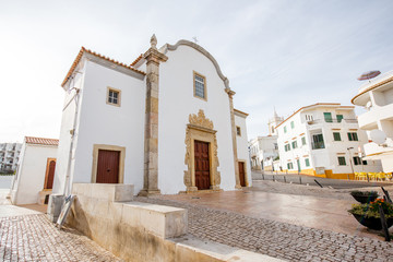 Cityscape view on the old town with beautiful white houses and church in Albufeira city on the south of Portugal © rh2010