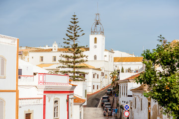 Cityscape view on the old town with beautiful white houses and church in Albufeira city on the south of Portugal © rh2010