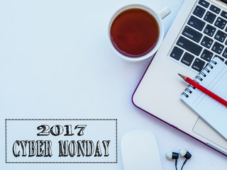 Cyber Monday words with office accessories on white background.