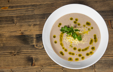 mushroom cream soup on wooden on a wooden background. with copy space. top view