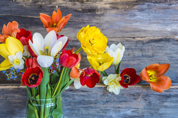 bouquet of fresh multicolored tulips on rustic background