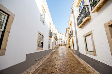 Street view with white houses in the old town of Faro on the south of Portugal