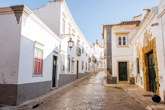 Street view with white houses in the old town of Faro on the south of Portugal