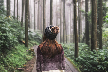 Young woman traveler walking in the forest