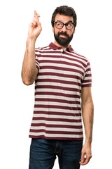 Man with glasses with his fingers crossing