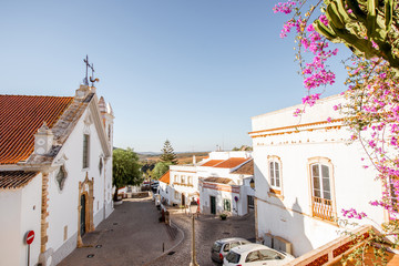 Typical village with white old church during the sunrise on the south of Portugal