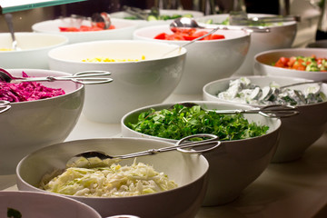Salad bar. Fresh vegetables in white bowls
