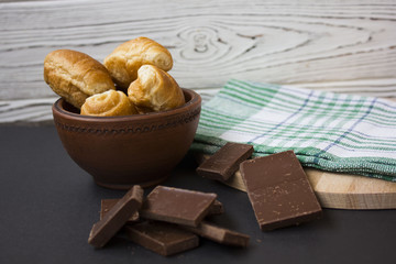 croissants and chocolate pieces on a wooden table