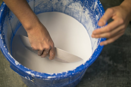 Crop person working with liquid clay