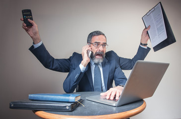Pressured businessman multitasking