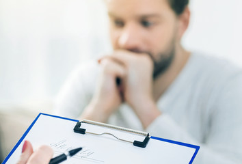 Depression symptoms. Selective focus of a psychologists notes taken during a psychological session