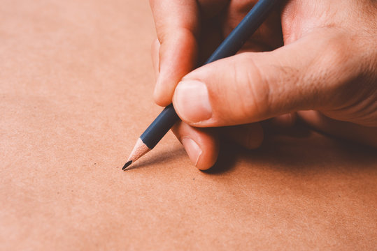 Male illustrator and sketch artist drawing with pencil