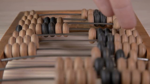 Man uses vintage old abacus