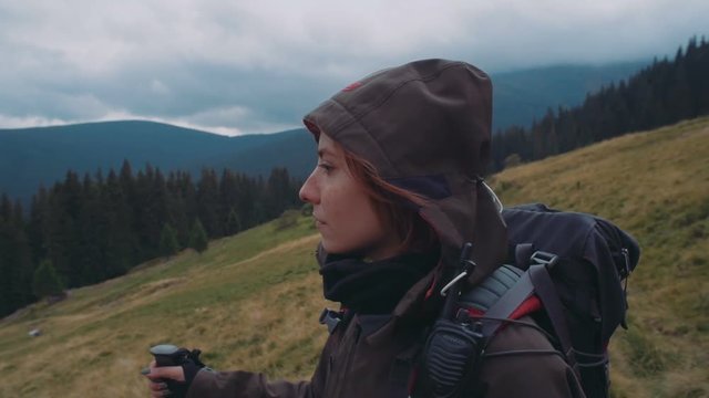 young caucasian female hiking in mountains