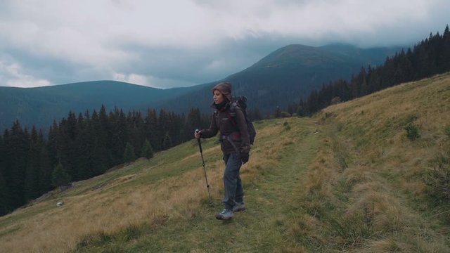 young caucasian female hiking in mountains