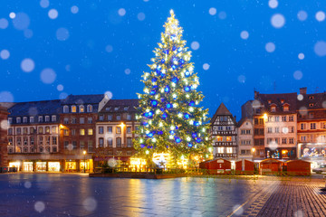 Fototapeta na wymiar Christmas Tree Decorated and illuminated on the Place Kleber in Old Town of Strasbourg at night, Alsace, France
