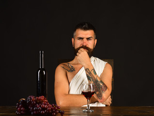 Winemaking and degustation concept. Man with beard near alcohol