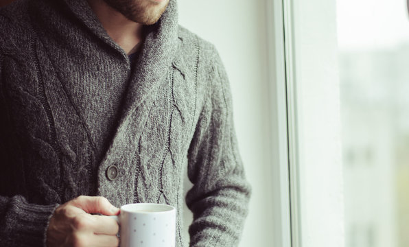 A man drinks coffee or tea