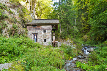 Old water mill in the forest thicket. Western Carinthia, Austria
