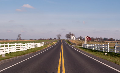 Fototapeta na wymiar A paved road through farmland in the United States