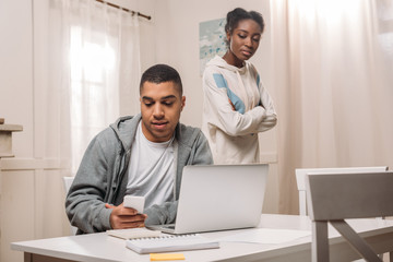 african american couple using laptop