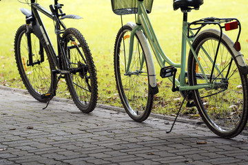 Fototapeta na wymiar two parked bikes in the park