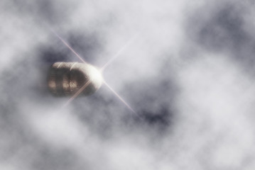 bullet flying mid-air through clouds with star spectral reflection - obrazy, fototapety, plakaty