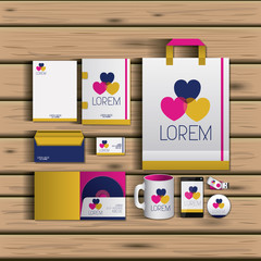 templates of hearts of corporate stationery over wooden background