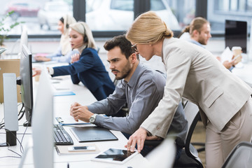 businesswoman helping colleague