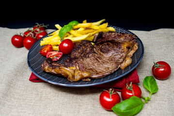 juicy steak beef meat with tomato and french fries