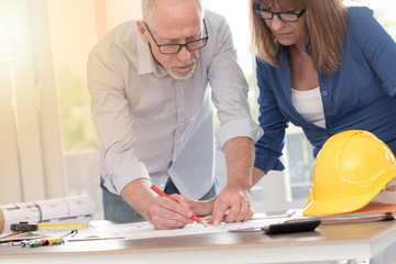 Obraz premium Architects working on plans, light effect