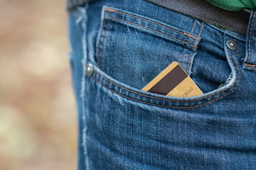 Closeup of credit card in jeans trousers pocket