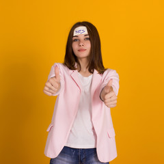 Young cute girl, sticker on a head, studio 