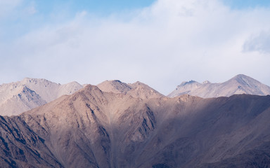 Closeup image of mountains and blue sky with clouds background in Ladakh , India