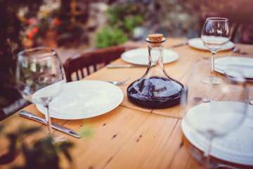 Wine decanter and glasses on dining table