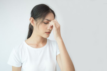 Fototapeta premium Woman touching her head with hands. Young asian woman feel headache. Isolated on white background.
