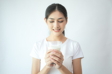 Young Asian Woman holding milk with smile on white background.