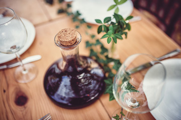 Wine decanter and glasses on dining table