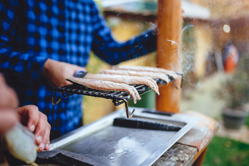 Men grilling fish on electric barbecue