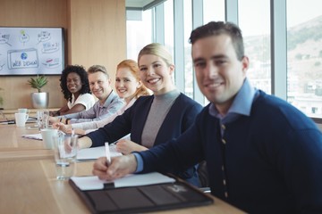 Portrait of smiling business people sitting at office
