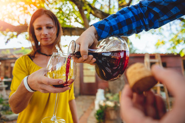 Man pouring red wine from decanter