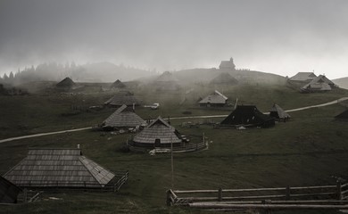 Cottages in mist in Velika Planina (Slovenia)