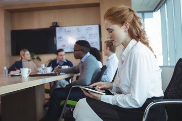 Fototapeta premium Side view of businesswoman using digital tablet at office