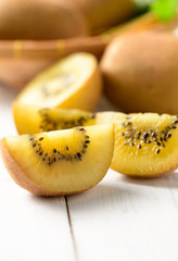 yellow sliced kiwi fruit on white wood