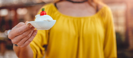 Women holding small bowl with cheese cream