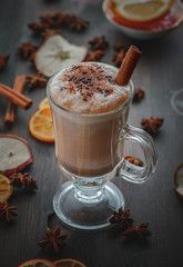 Delicious hot chocolate with cinnamon on the brown wood table