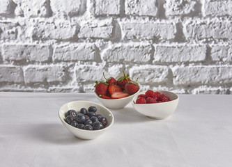 Berries mix blueberry, raspberry, red currant, strawberry on the white table