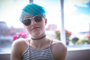Woman in sunglasses posing at home